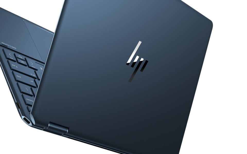 An HP Spectre laptop on a side view close up, showing a virtual meeting in the screen.